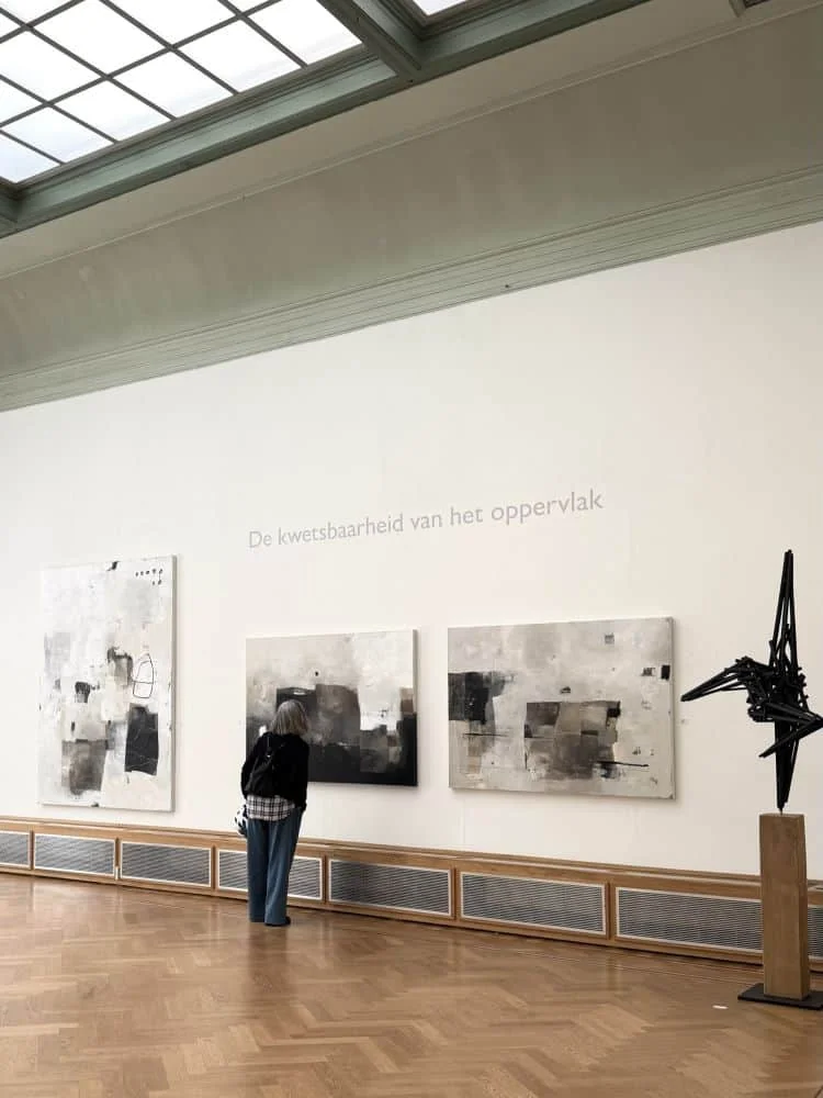an exhibition in the beautiful, classic Pulchri studio in the Hague. with white walls and the art from Jolanda Wasssenaar. a herringbone wooden floor and a glass ceiling